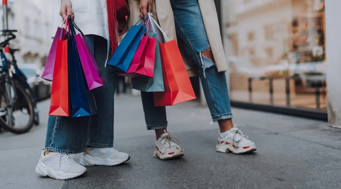 two women holding shopping bag