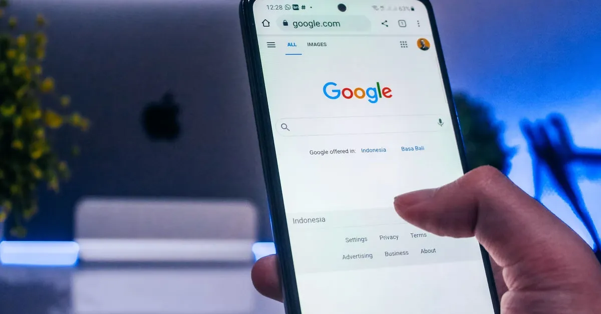 A person using the smartphone, specifically the Google App.