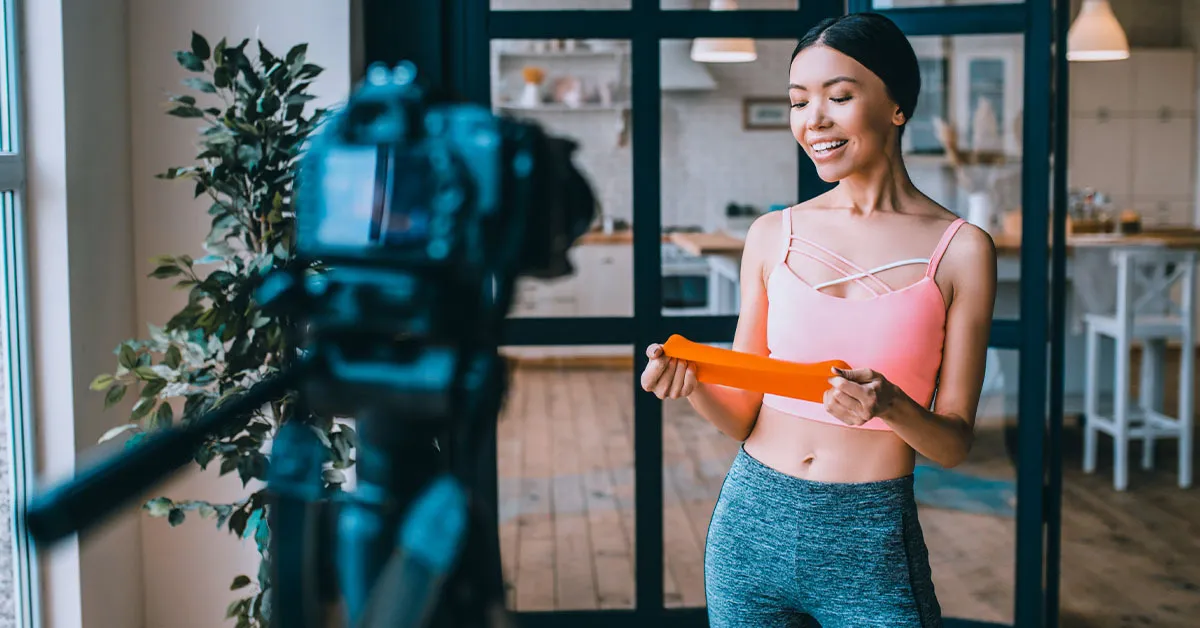 A woman creating a video using a professional camera.
