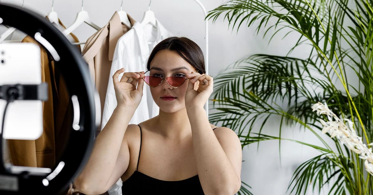 Woman wearing sunglasses and creating UGC