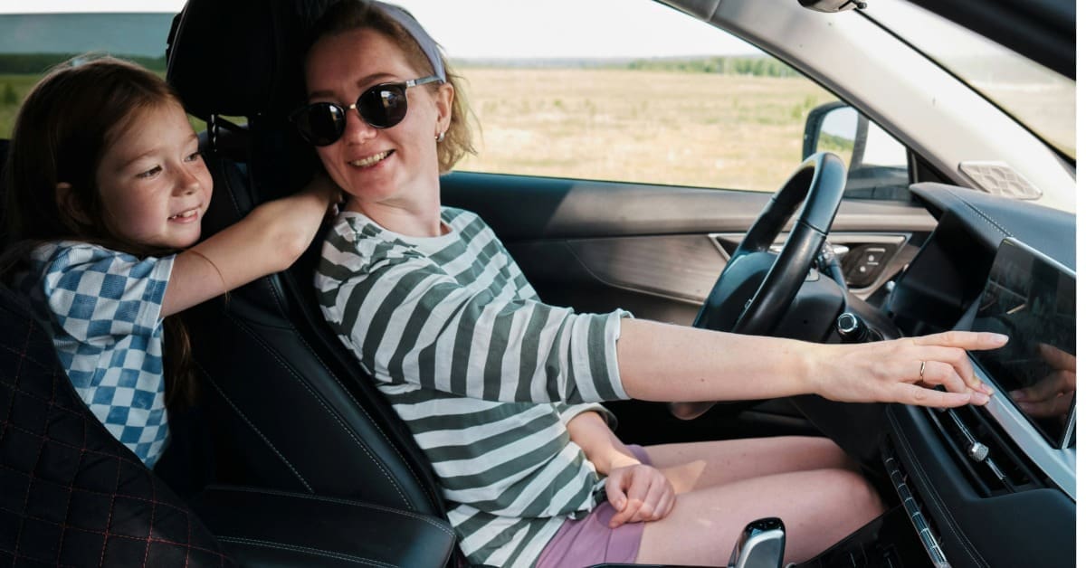 Woman and child in a car listening to the radio.