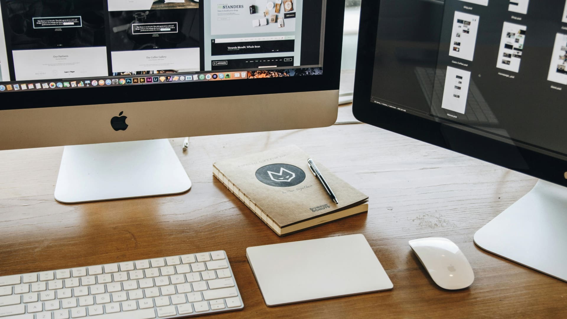 Two computers displaying the design process of a website redesign.