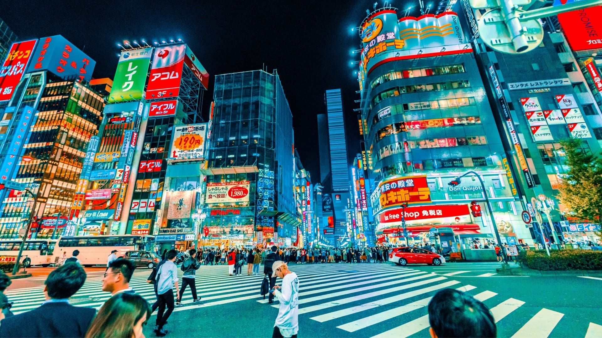 Digital billboards displaying multilingual advertisements.